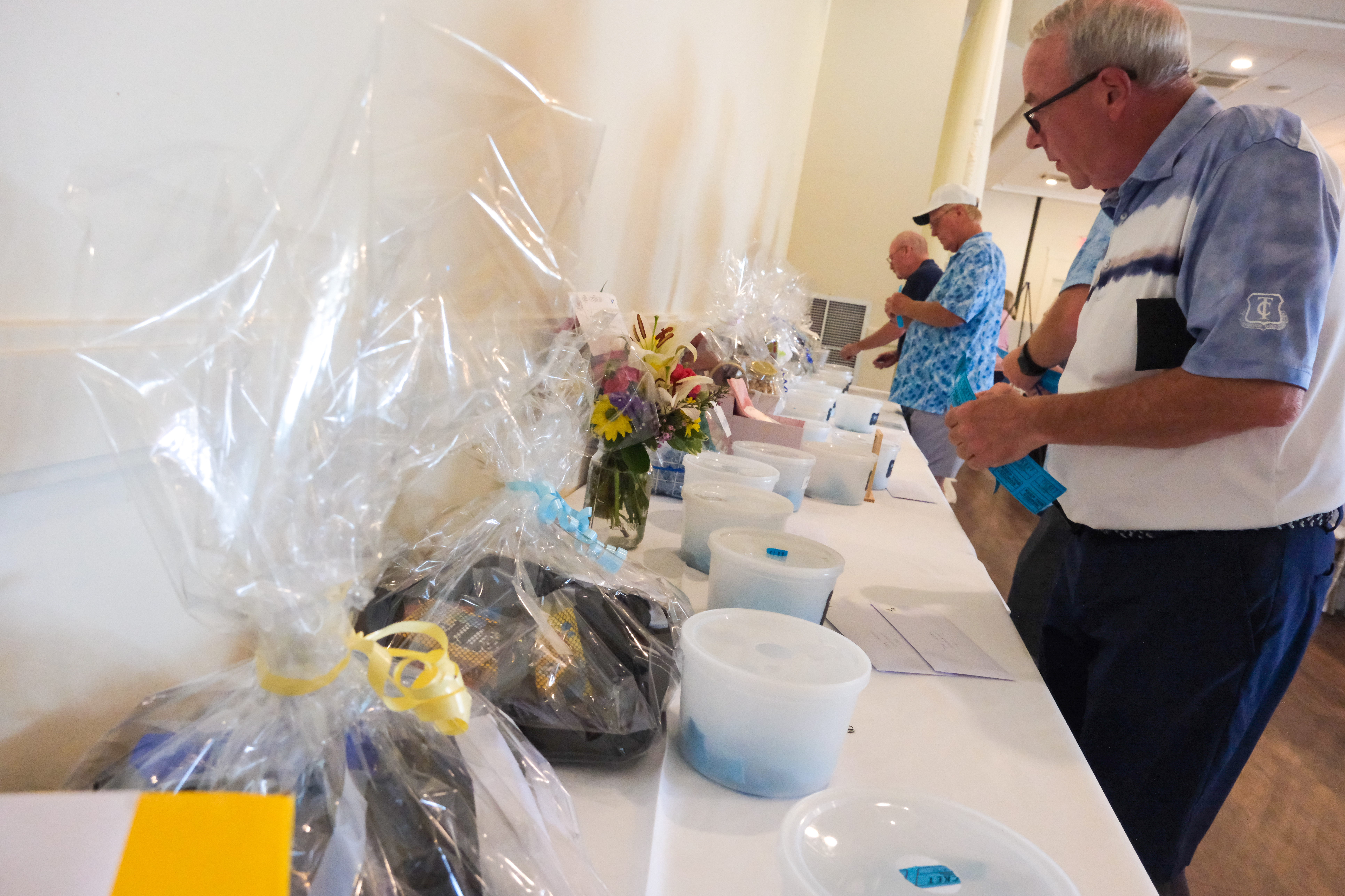 putting raffle tickets in Basket